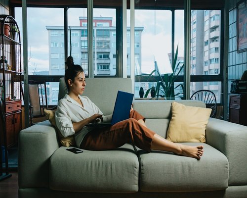 A person resting comfortably at home on a sofa after an everyday routine